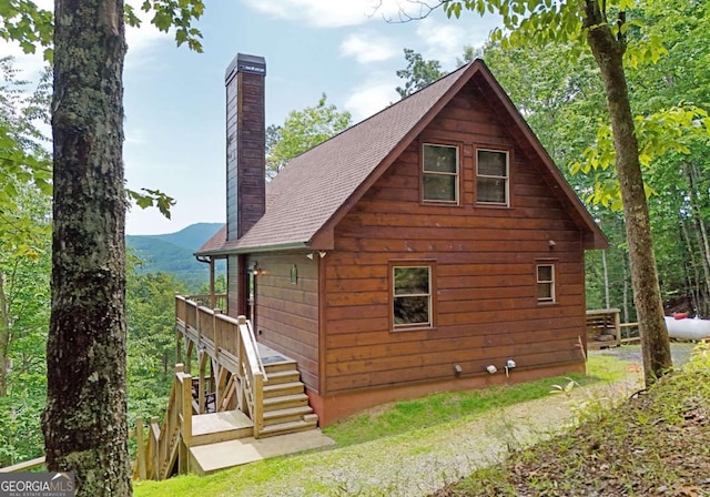 73 Rosiey Ln Unit 356, Blue Ridge, GA 30513 - view of home's exterior featuring a chimney, stairs, roof with shingles, and a deck