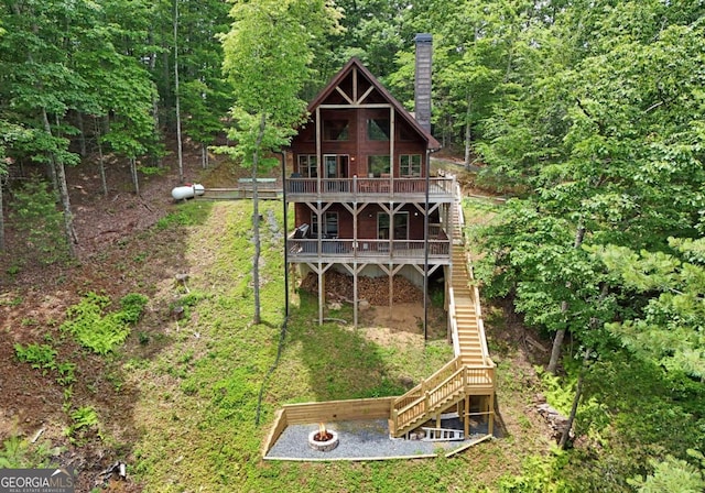73 Rosiey Ln Unit 356, Blue Ridge, GA 30513 - back of house featuring stairs, an outdoor fire pit, a chimney, a wooden deck, and a forest view
