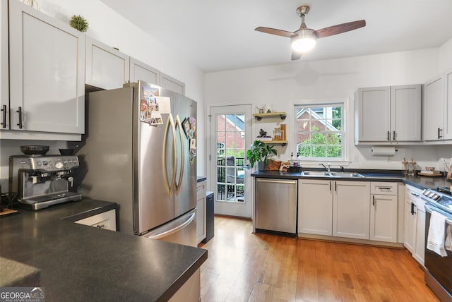 3675 Peachtree Rd NE Apt 24, Atlanta, GA 30319 - kitchen featuring stainless steel appliances, dark countertops, light wood finished floors, and a ceiling fan