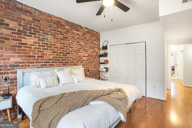 3675 Peachtree Rd NE Apt 24, Atlanta, GA 30319 - bedroom with brick wall, a closet, wood finished floors, and ceiling fan