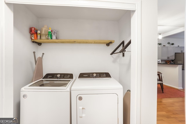 3675 Peachtree Rd NE Apt 24, Atlanta, GA 30319 - laundry room featuring washing machine and clothes dryer and light wood-style flooring