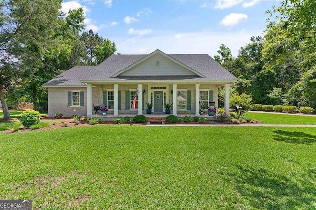 162 Drakes Lndg, Brunswick, GA 31523 - view of front facade featuring covered porch, a front lawn, and roof with shingles