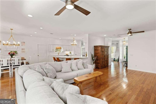 162 Drakes Lndg, Brunswick, GA 31523 - living room with a chandelier, a ceiling fan, recessed lighting, and light wood-type flooring