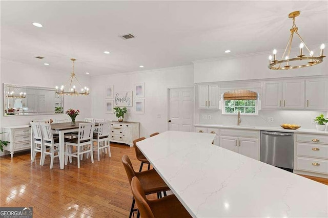 162 Drakes Lndg, Brunswick, GA 31523 - kitchen featuring a chandelier, dishwasher, crown molding, pendant lighting, and wood finished floors