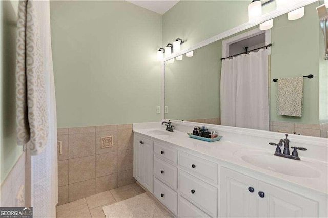 162 Drakes Lndg, Brunswick, GA 31523 - full bathroom with double vanity, tile walls, tile patterned flooring, and a wainscoted wall