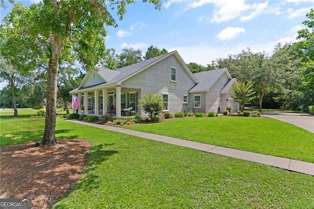162 Drakes Lndg, Brunswick, GA 31523 - view of front of house featuring a porch, a front yard, and concrete driveway