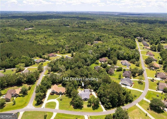 162 Drakes Lndg, Brunswick, GA 31523 - aerial perspective of suburban area with a heavily wooded area