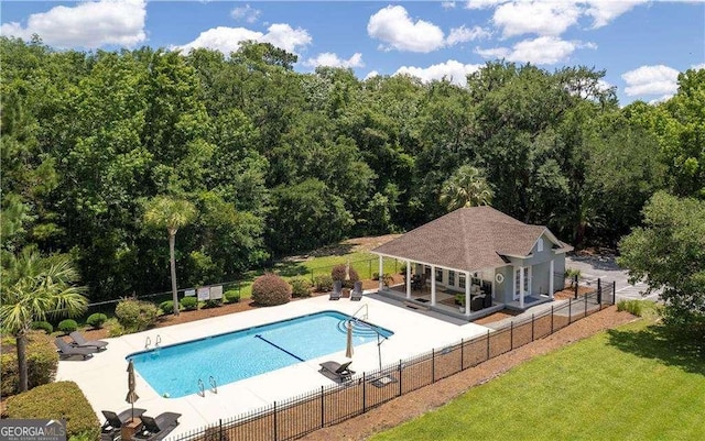 162 Drakes Lndg, Brunswick, GA 31523 - view of swimming pool with a patio, an outbuilding, and a wooded view