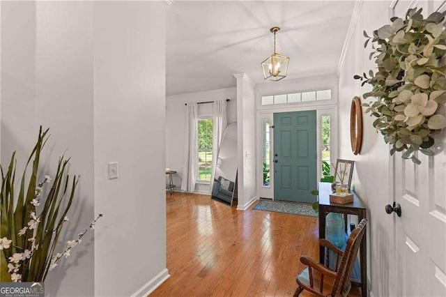 162 Drakes Lndg, Brunswick, GA 31523 - entryway with ornamental molding, a chandelier, and hardwood / wood-style floors