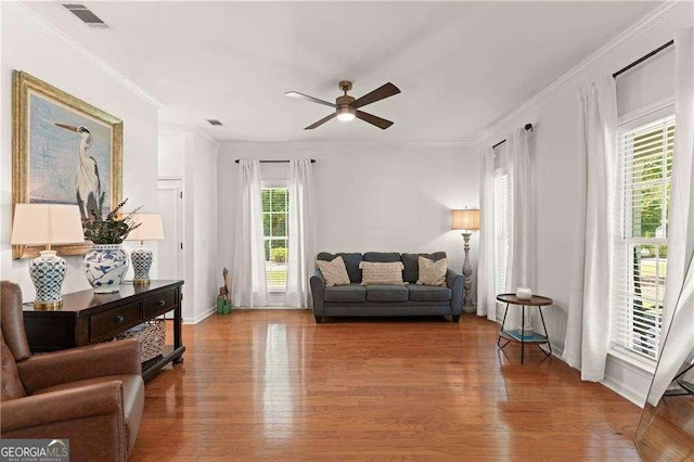 162 Drakes Lndg, Brunswick, GA 31523 - living room featuring ceiling fan, ornamental molding, and wood finished floors