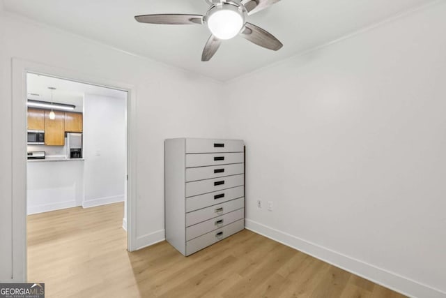 171 Auburn Ave NE Unit 210, Atlanta, GA 30303 - unfurnished bedroom with stainless steel fridge, light wood finished floors, and a ceiling fan