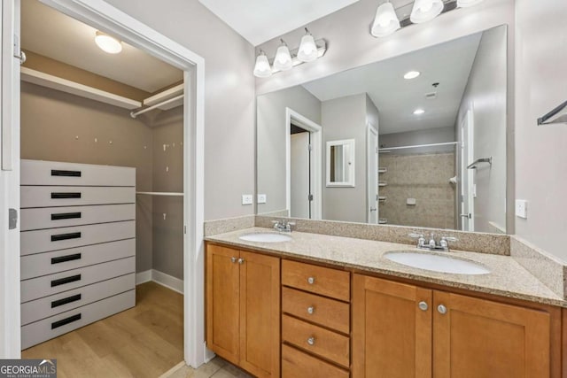 171 Auburn Ave NE Unit 210, Atlanta, GA 30303 - bathroom featuring double vanity, wood finished floors, a walk in closet, and a shower