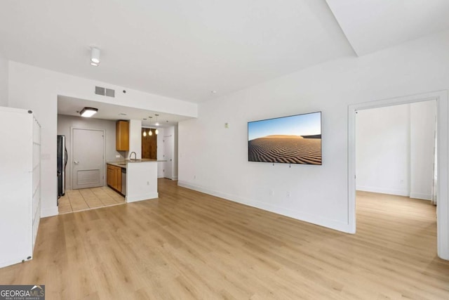 171 Auburn Ave NE Unit 210, Atlanta, GA 30303 - unfurnished living room featuring light wood-style floors and baseboards