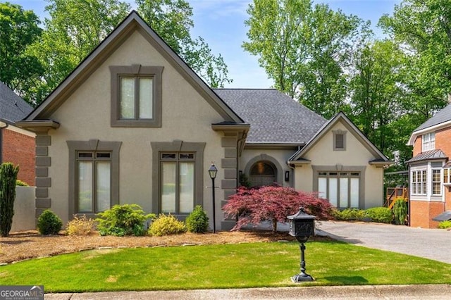 4569 Fountain Dr, Marietta, GA 30067 - view of front facade with stucco siding, a front yard, and a shingled roof