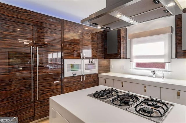 4569 Fountain Dr, Marietta, GA 30067 - kitchen with wall chimney exhaust hood, gas stovetop, light countertops, and tasteful backsplash