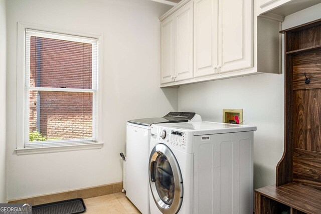 4569 Fountain Dr, Marietta, GA 30067 - laundry area with cabinet space, washing machine and clothes dryer, and light tile patterned floors