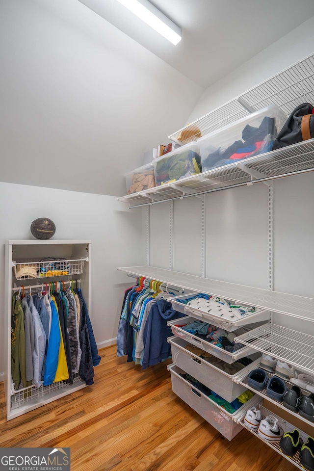 4569 Fountain Dr, Marietta, GA 30067 - spacious closet featuring wood finished floors and vaulted ceiling