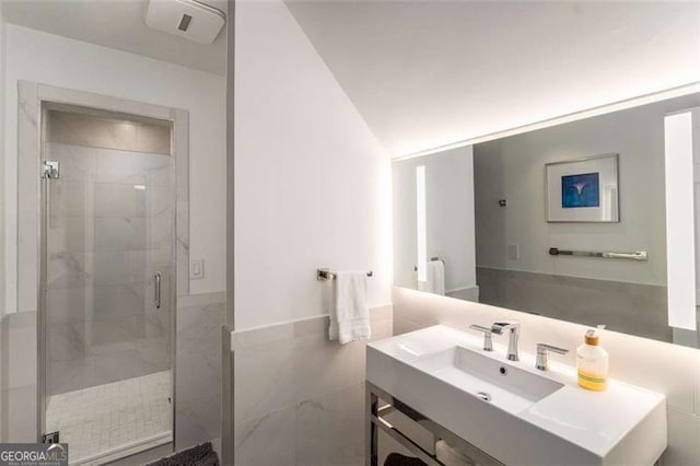 4569 Fountain Dr, Marietta, GA 30067 - bathroom with vanity, a stall shower, tile walls, and a wainscoted wall