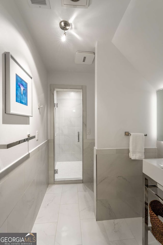 4569 Fountain Dr, Marietta, GA 30067 - full bathroom featuring a stall shower, tile walls, a wainscoted wall, vanity, and marble finish flooring