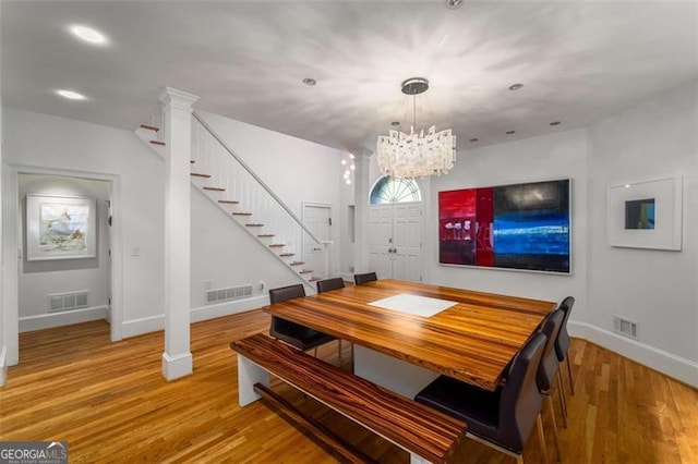 4569 Fountain Dr, Marietta, GA 30067 - dining area with stairway, a chandelier, wood finished floors, and recessed lighting