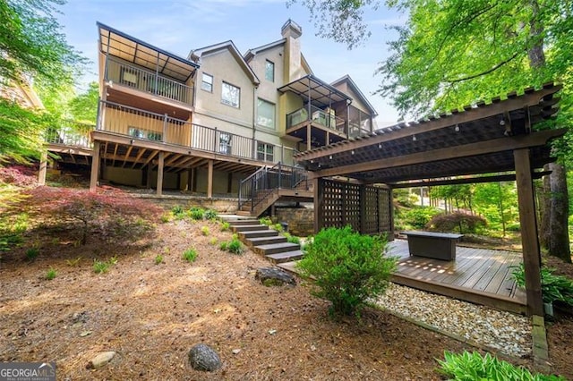 4569 Fountain Dr, Marietta, GA 30067 - rear view of house with a wooden deck, a chimney, and stairway