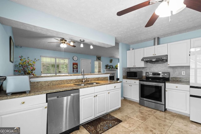 580 Lilburn School Rd, Lilburn, GA 30047 - kitchen featuring stainless steel appliances, under cabinet range hood, a ceiling fan, white cabinetry, and decorative backsplash