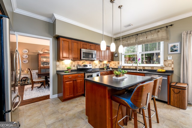 1767 Tidewell Trce, Lawrenceville, GA 30043 - kitchen with stainless steel appliances, dark countertops, crown molding, tasteful backsplash, and a kitchen bar