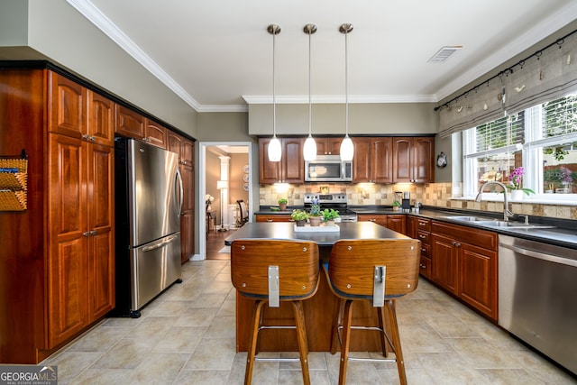 1767 Tidewell Trce, Lawrenceville, GA 30043 - kitchen featuring appliances with stainless steel finishes, dark countertops, a center island, light tile patterned floors, and crown molding
