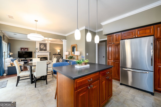 1767 Tidewell Trce, Lawrenceville, GA 30043 - kitchen with freestanding refrigerator, dark countertops, ornamental molding, a fireplace, and decorative columns