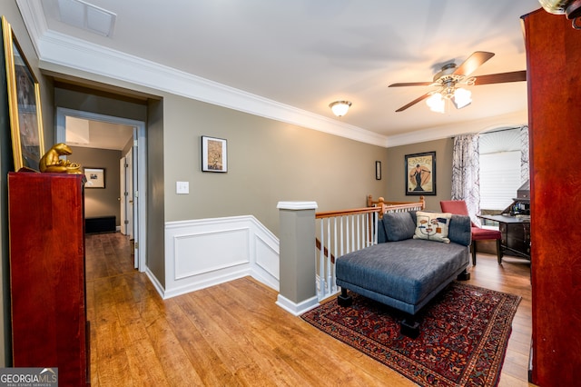 1767 Tidewell Trce, Lawrenceville, GA 30043 - living area with an upstairs landing, wood finished floors, ceiling fan, and ornamental molding