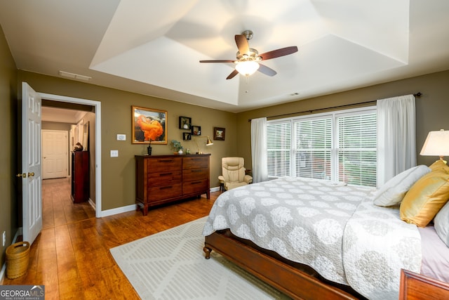 1767 Tidewell Trce, Lawrenceville, GA 30043 - bedroom featuring a raised ceiling, wood finished floors, and ceiling fan