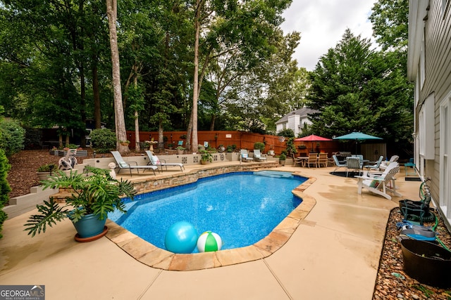 1767 Tidewell Trce, Lawrenceville, GA 30043 - view of swimming pool featuring a patio area, outdoor dining area, a fenced backyard, and view of wooded area