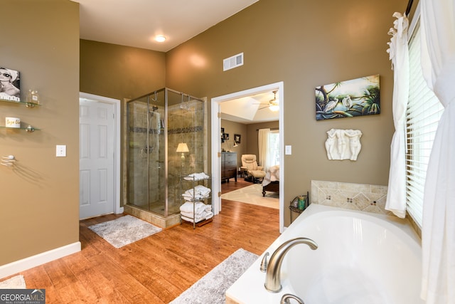 1767 Tidewell Trce, Lawrenceville, GA 30043 - full bathroom featuring a bath, a stall shower, ensuite bath, wood finished floors, and ceiling fan