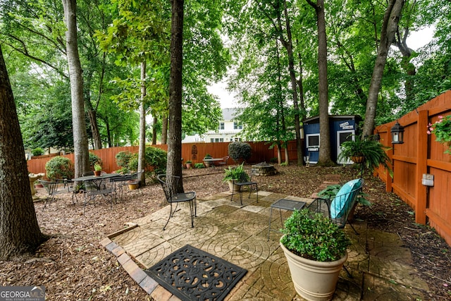 1767 Tidewell Trce, Lawrenceville, GA 30043 - fenced backyard with a patio and a storage unit