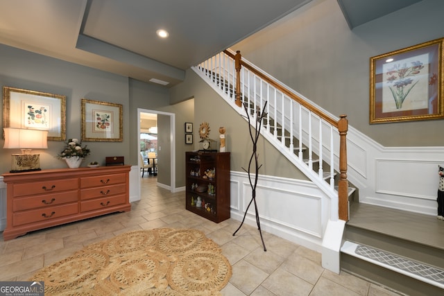 1767 Tidewell Trce, Lawrenceville, GA 30043 - stairs featuring a decorative wall, wainscoting, tile patterned flooring, and recessed lighting