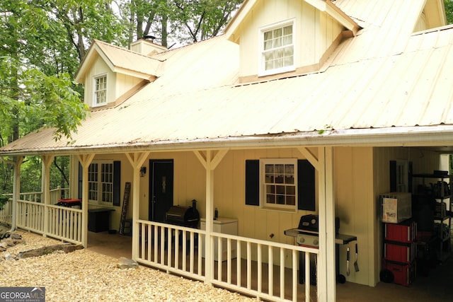 317 Running Deer Rd, Cleveland, GA 30528 - rear view of house featuring a chimney, a metal roof, and washer / clothes dryer