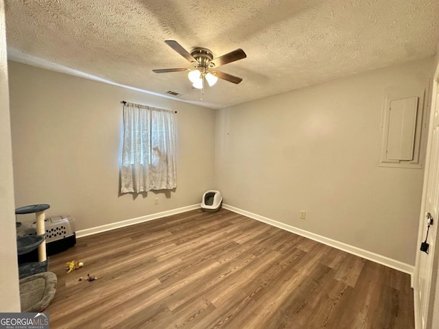 317 Running Deer Rd, Cleveland, GA 30528 - empty room featuring a ceiling fan, dark wood-type flooring, electric panel, and a textured ceiling
