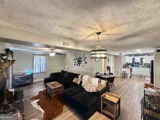 317 Running Deer Rd, Cleveland, GA 30528 - living area featuring a textured ceiling, light wood-style flooring, stairway, and a ceiling fan