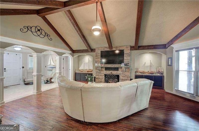 186 Wolverine Dr, Waleska, GA 30183 - living area featuring decorative columns, wood finished floors, and a stone fireplace