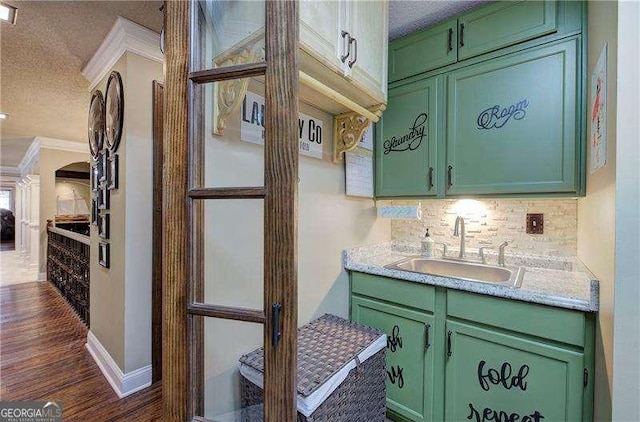 186 Wolverine Dr, Waleska, GA 30183 - kitchen featuring green cabinetry, a textured ceiling, tasteful backsplash, ornamental molding, and dark wood-style flooring