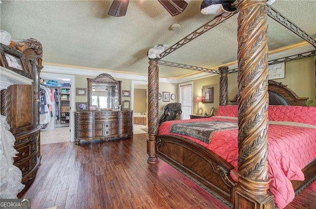 186 Wolverine Dr, Waleska, GA 30183 - bedroom with a textured ceiling, ornate columns, ornamental molding, wood finished floors, and a ceiling fan