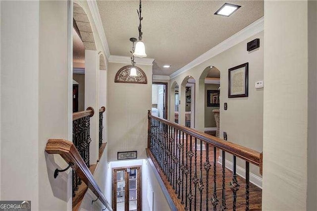 186 Wolverine Dr, Waleska, GA 30183 - corridor featuring ornamental molding, a textured ceiling, arched walkways, and an upstairs landing