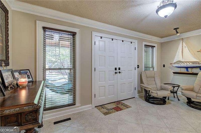186 Wolverine Dr, Waleska, GA 30183 - entryway with a textured ceiling, crown molding, and light tile patterned floors