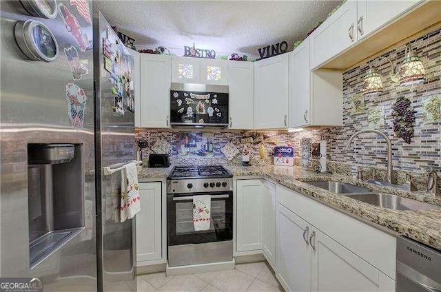 186 Wolverine Dr, Waleska, GA 30183 - kitchen with appliances with stainless steel finishes, white cabinetry, backsplash, and a textured ceiling