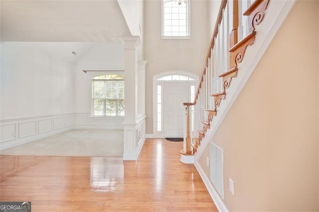 1979 Spivey Vlg, Jonesboro, GA 30236 - foyer featuring plenty of natural light, wood finished floors, stairs, high vaulted ceiling, and a decorative wall