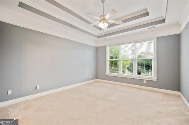 1979 Spivey Vlg, Jonesboro, GA 30236 - carpeted empty room featuring a tray ceiling, ornamental molding, and a ceiling fan