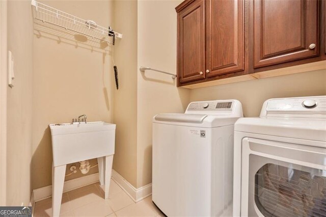 1979 Spivey Vlg, Jonesboro, GA 30236 - laundry room with washing machine and dryer, cabinet space, and light tile patterned floors
