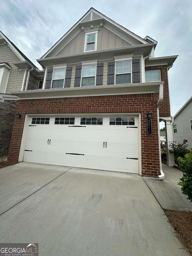 2060 Lanier Harbor Pt, Buford, GA 30518 - view of front facade featuring board and batten siding, driveway, and brick siding