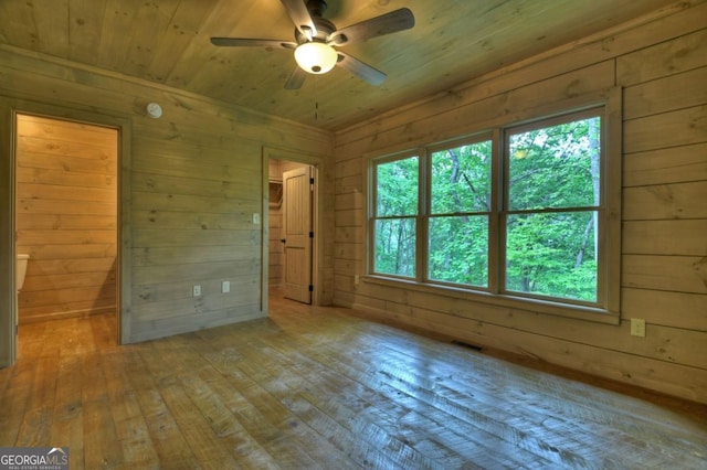 85 Christopher Dr Unit 108, Ellijay, GA 30540 - unfurnished room featuring hardwood / wood-style floors, wood walls, plenty of natural light, a ceiling fan, and wooden ceiling