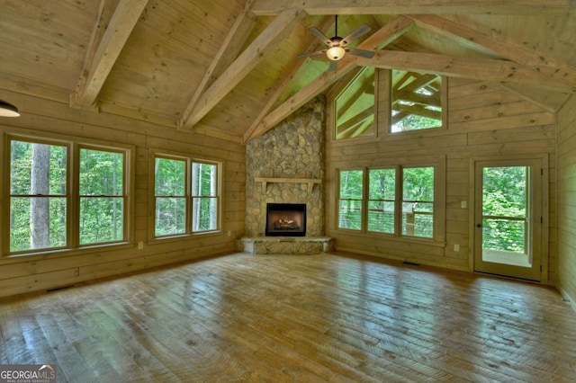 85 Christopher Dr Unit 108, Ellijay, GA 30540 - unfurnished living room with high vaulted ceiling, wood-type flooring, wood walls, a stone fireplace, and ceiling fan